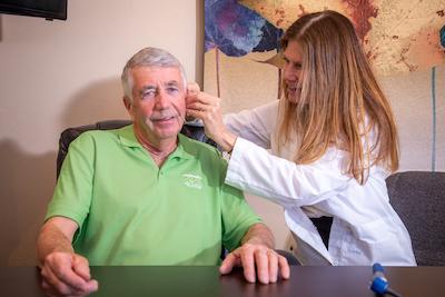 audiologist checking ear